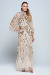 Celestine neutral-hued gold embellished maxi dress with flowing cape overlay, long sleeves, and modest elegant silhouette for weddings and formal occasions.