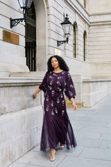 Naida dark purple embellished maxi dress with long sleeves, floral bead details, and floor-length flowing silhouette, suitable for weddings and formal occasions.