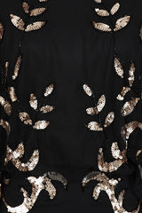 Black maxi dress with gold sequin floral embellishment, flowing sheer sleeves and full-length silhouette, Ambretta by Frock and Frill.