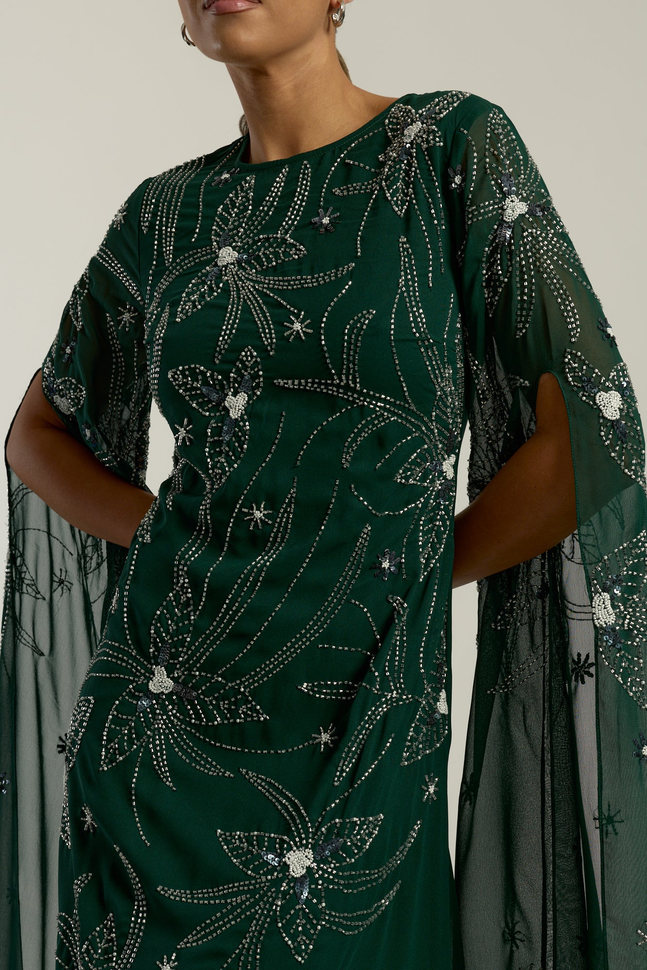 Eden green embellished cape sleeve maxi dress by Frock and Frill with delicate beadwork and a modest full-length silhouette