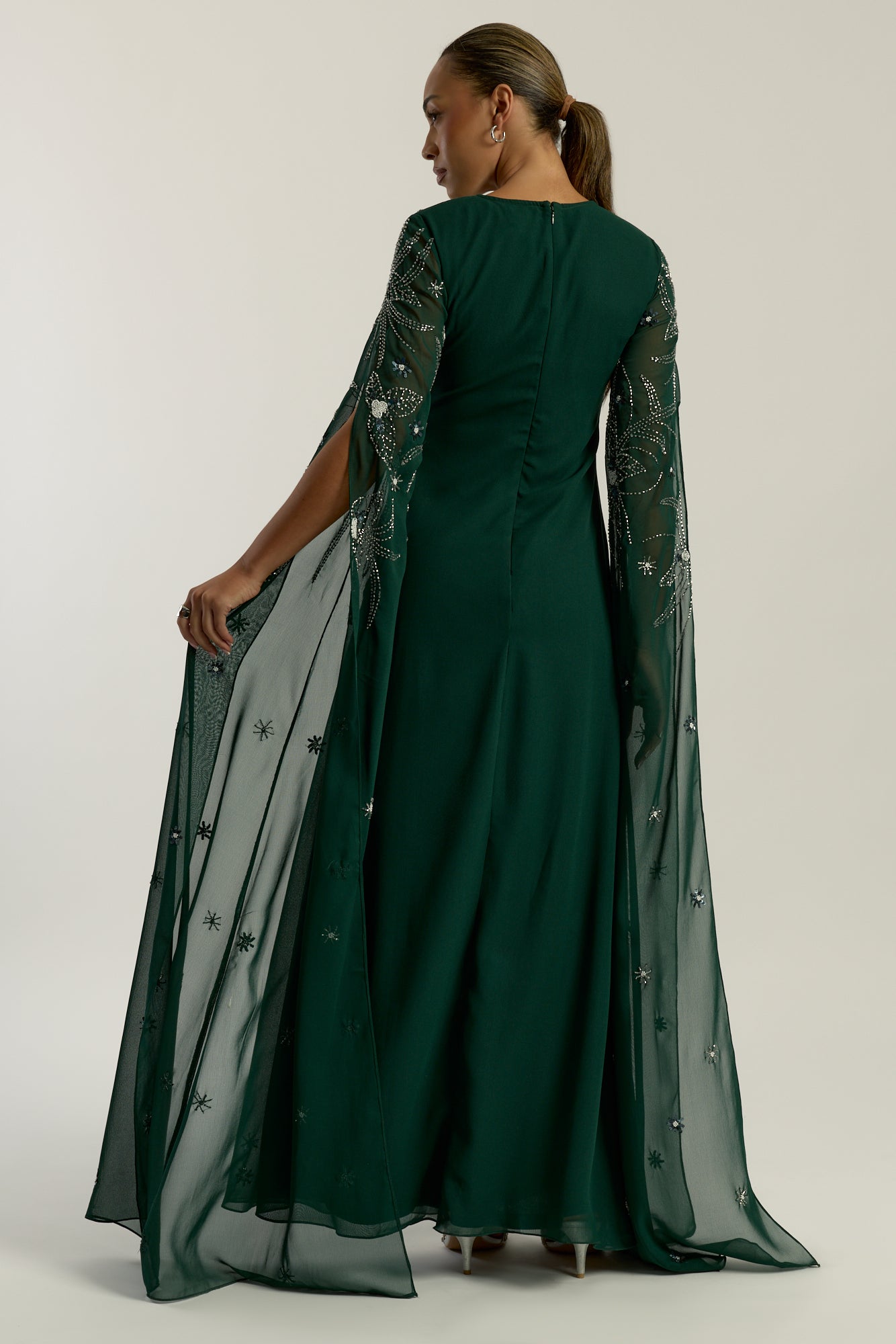 Eden green embellished cape sleeve maxi dress by Frock and Frill with delicate beadwork and a modest full-length silhouette