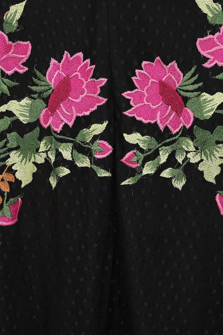 Frock and Frill Elena black midi dress with colourful floral embroidery, sheer polka dot mesh overlay, V neckline and flared sleeves.