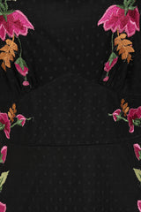 Frock and Frill Elena black midi dress with colourful floral embroidery, sheer polka dot mesh overlay, V neckline and flared sleeves.