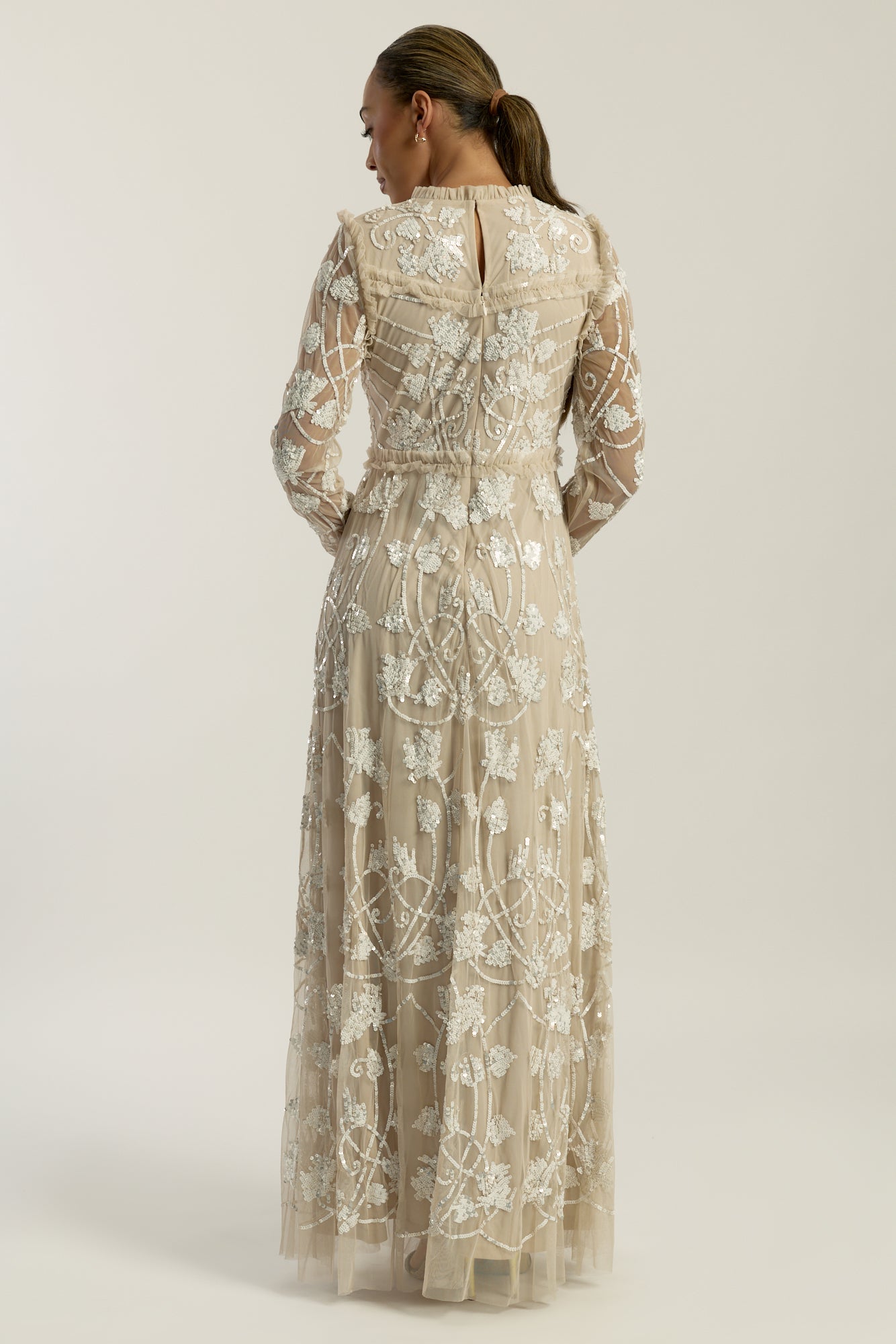 Elowen long sleeve embellished maxi dress by Frock and Frill UK in neutral tones with intricate white beadwork, modest style for weddings and formal occasions.