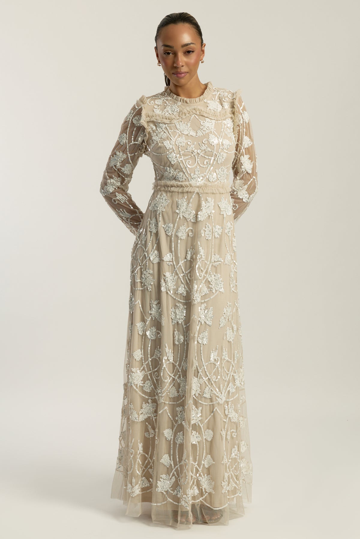 Elowen long sleeve embellished maxi dress by Frock and Frill UK in neutral tones with intricate white beadwork, modest style for weddings and formal occasions.