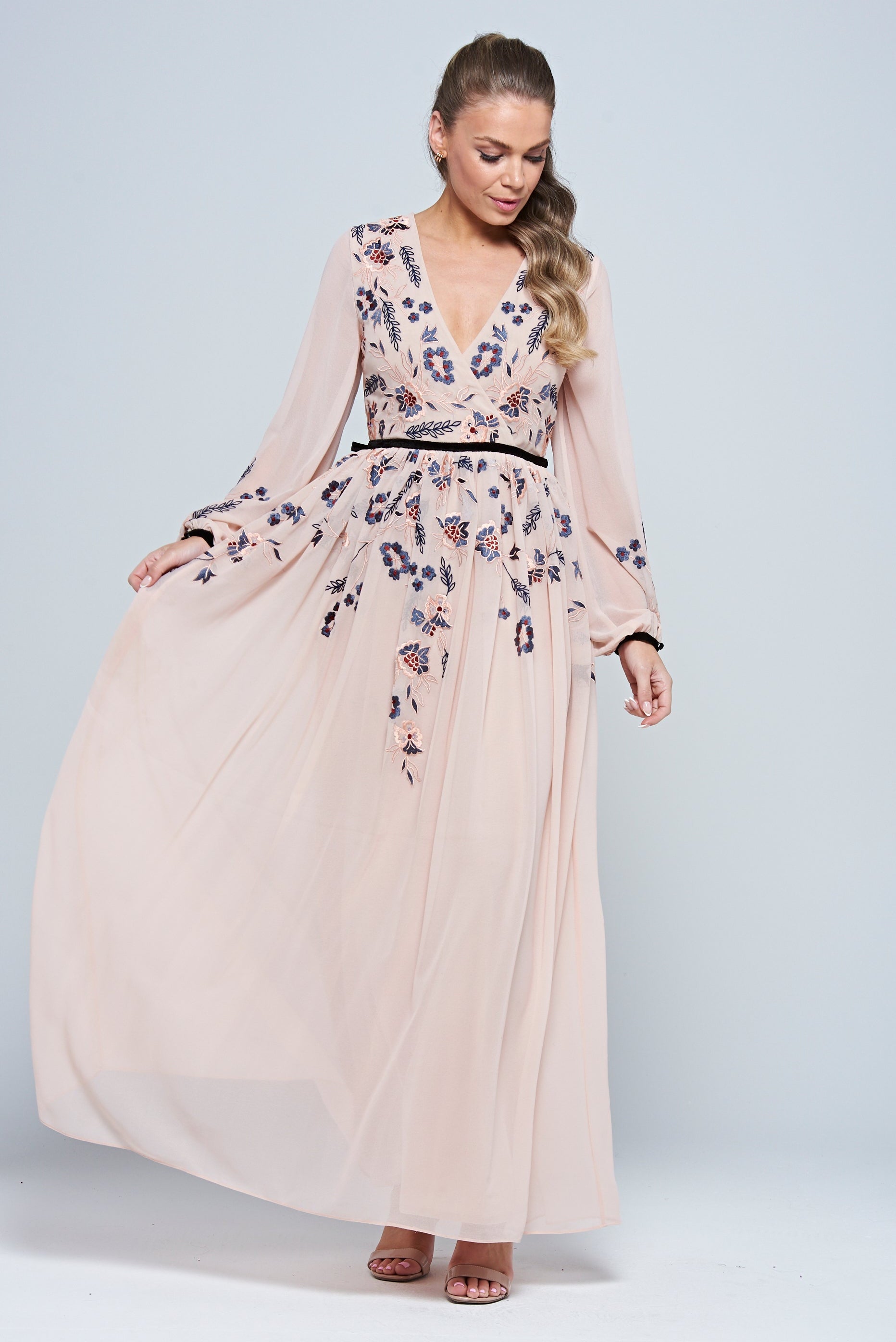Erica Blush Floral Embroidered Maxi Dress by Frock and Frill, featuring long sleeves, V-neckline, and flowing maxi skirt in soft blush tones.