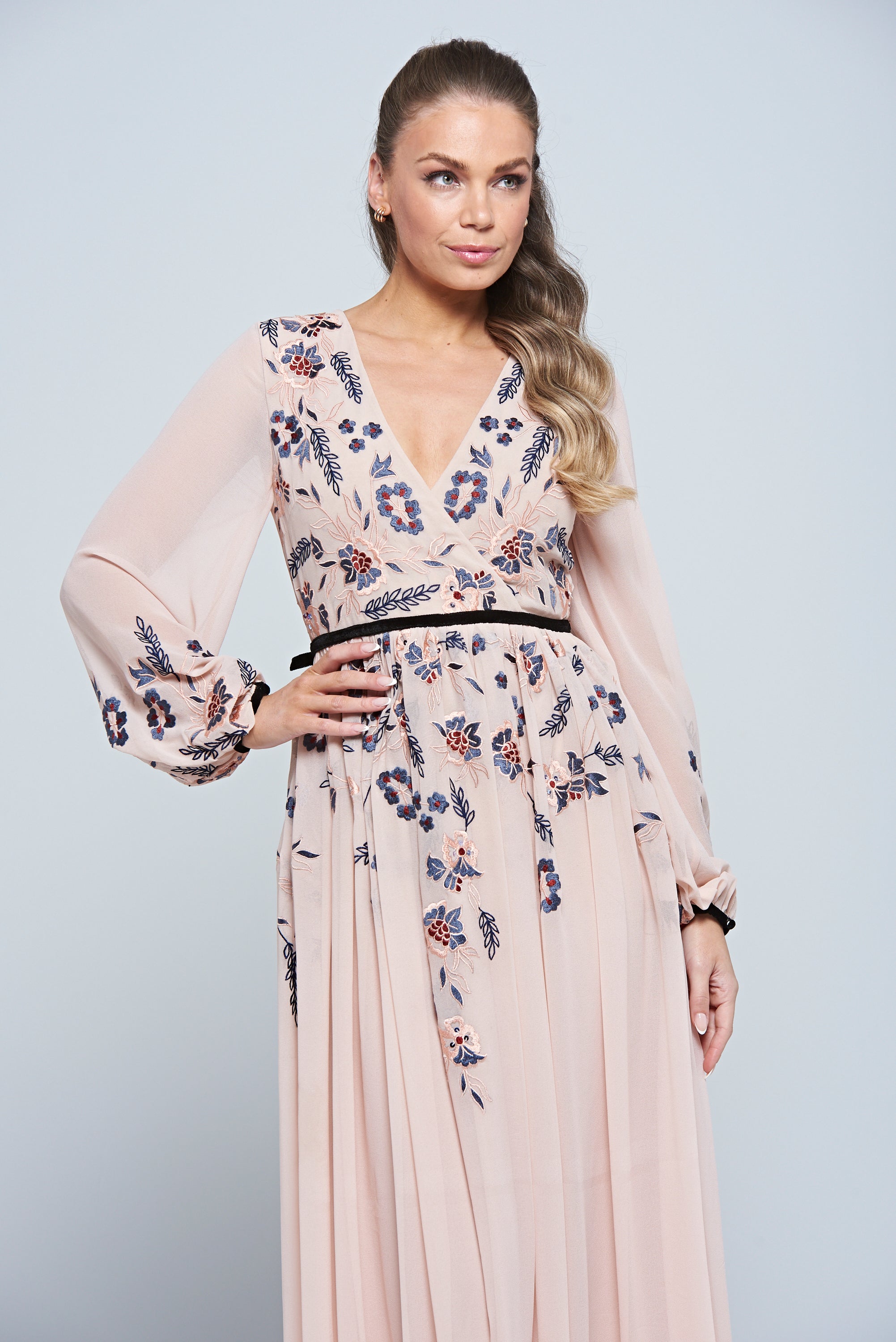 Erica Blush Floral Embroidered Maxi Dress by Frock and Frill, featuring long sleeves, V-neckline, and flowing maxi skirt in soft blush tones.