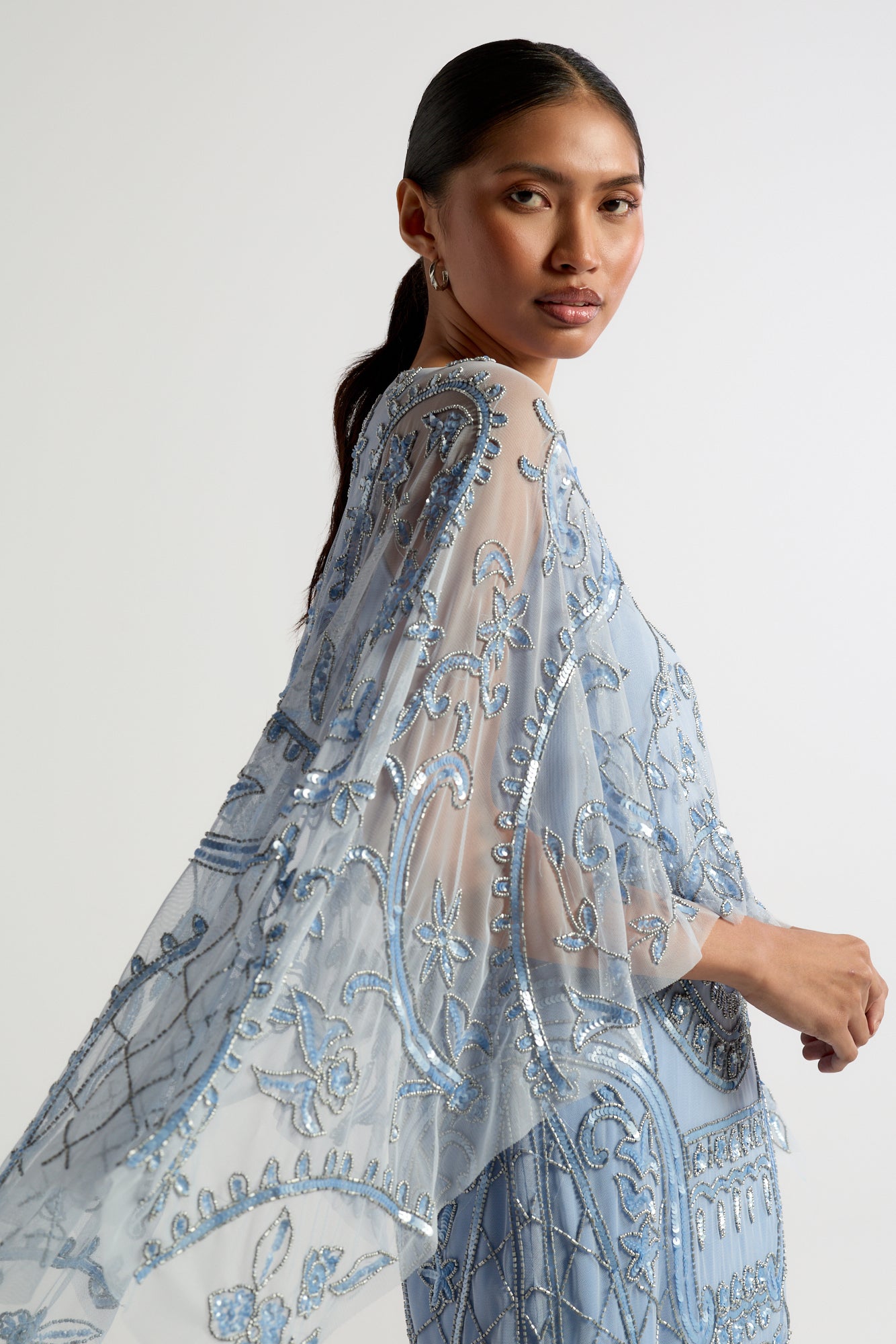 Juliana Blue Embellished Midi Dress With Cape Detail by Frock and Frill in cornflower blue with all-over beading and flowing cape overlay.