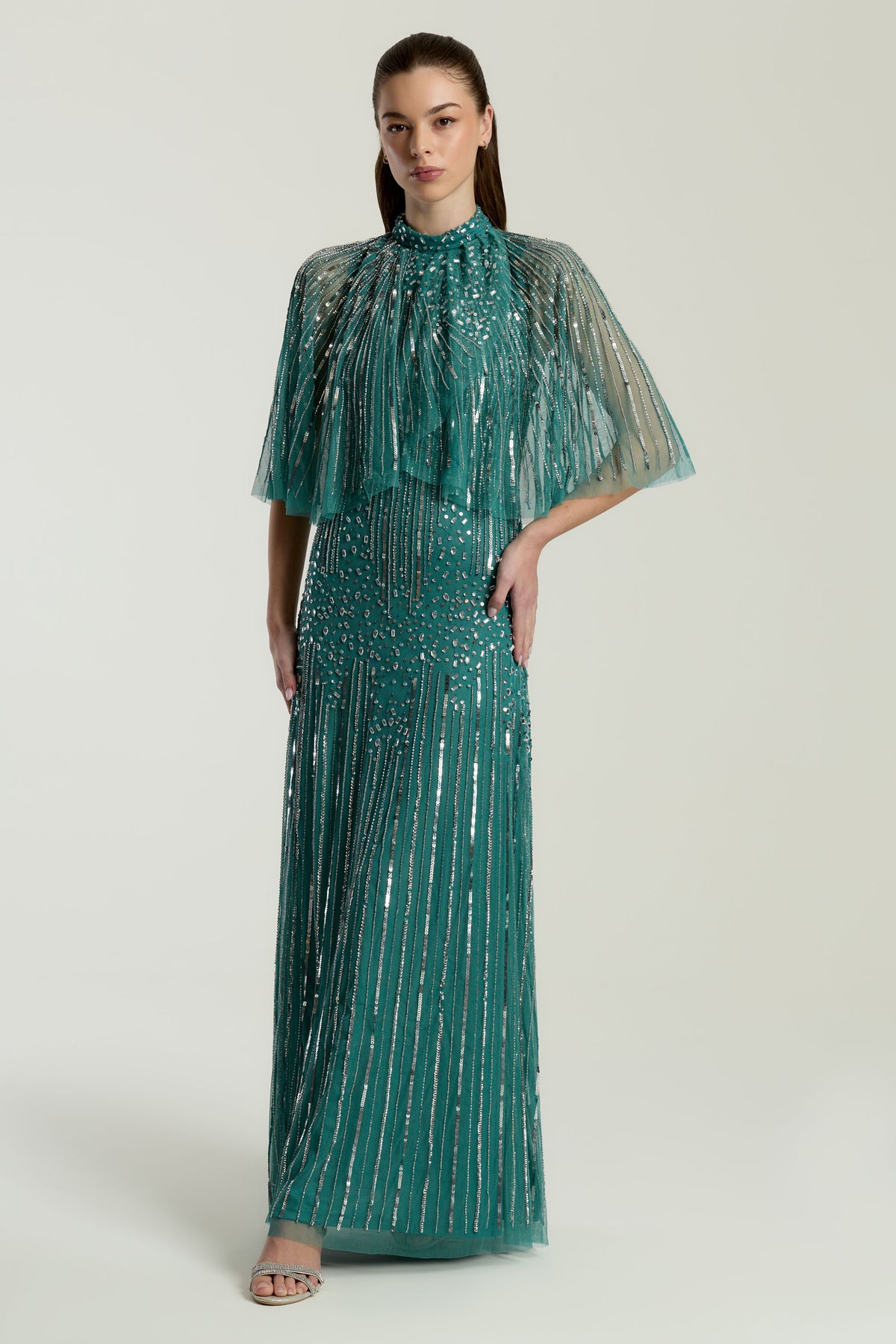Lisette Teal Embellished Maxi Dress with Cape Detail, floor-length gown with all over beading and sheer cape sleeves, suitable for weddings and evening events