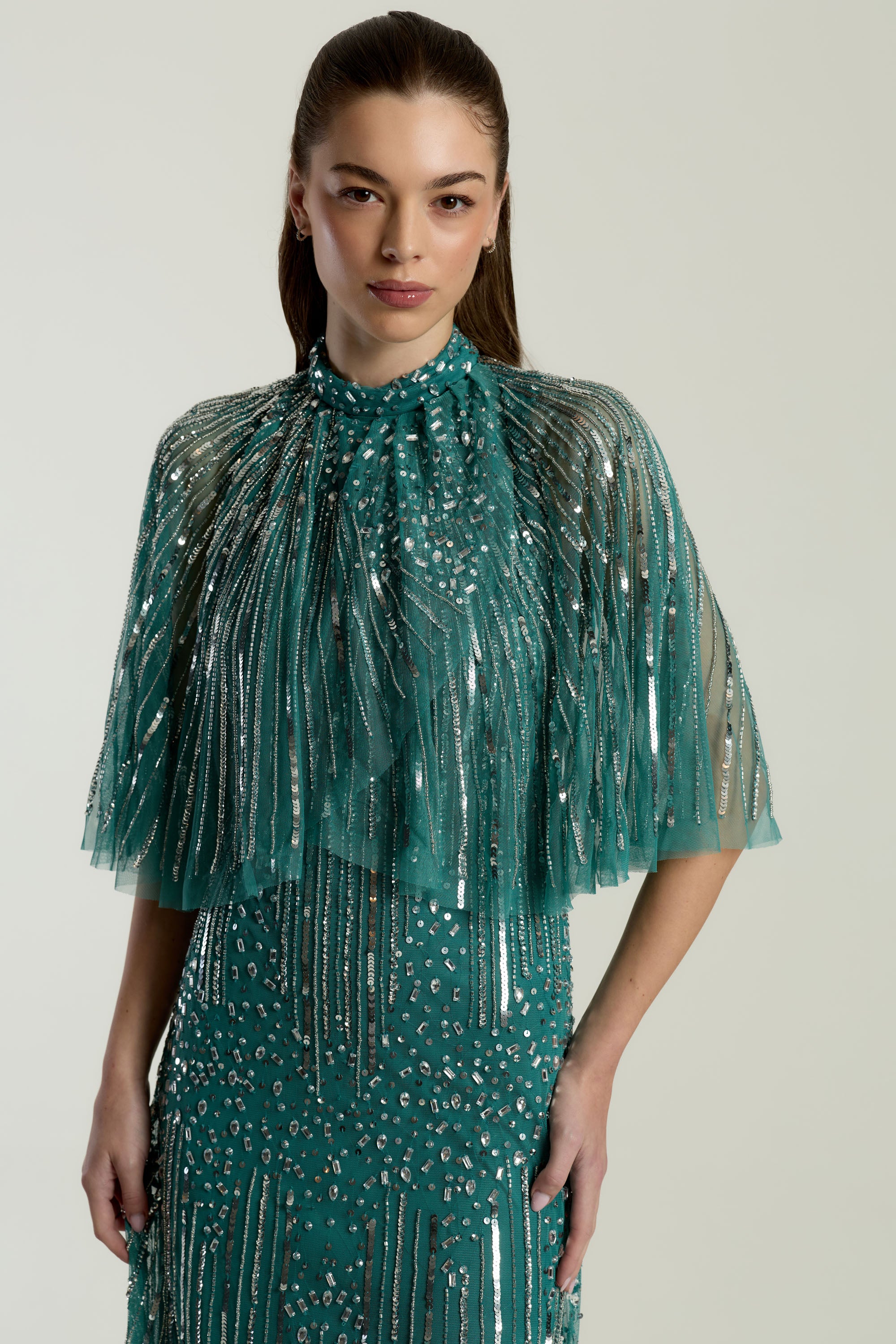 Lisette Teal Embellished Maxi Dress with Cape Detail, floor-length gown with all over beading and sheer cape sleeves, suitable for weddings and evening events