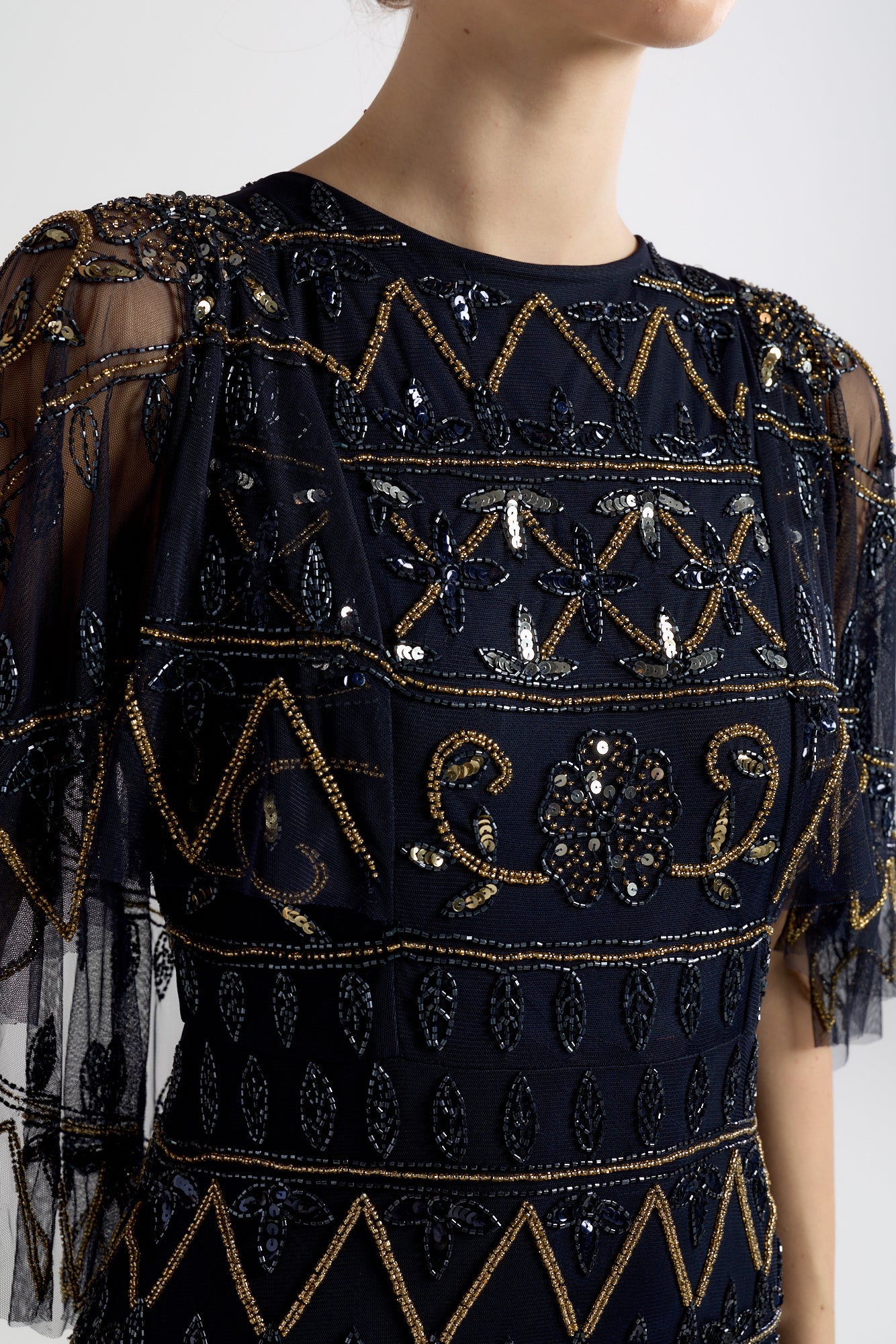 Navy Mahonia cape sleeve midaxi dress from Frock and Frill, fully embellished with sparkling beads, featuring a flowing skirt, perfect for weddings, parties, and modest evening occasions