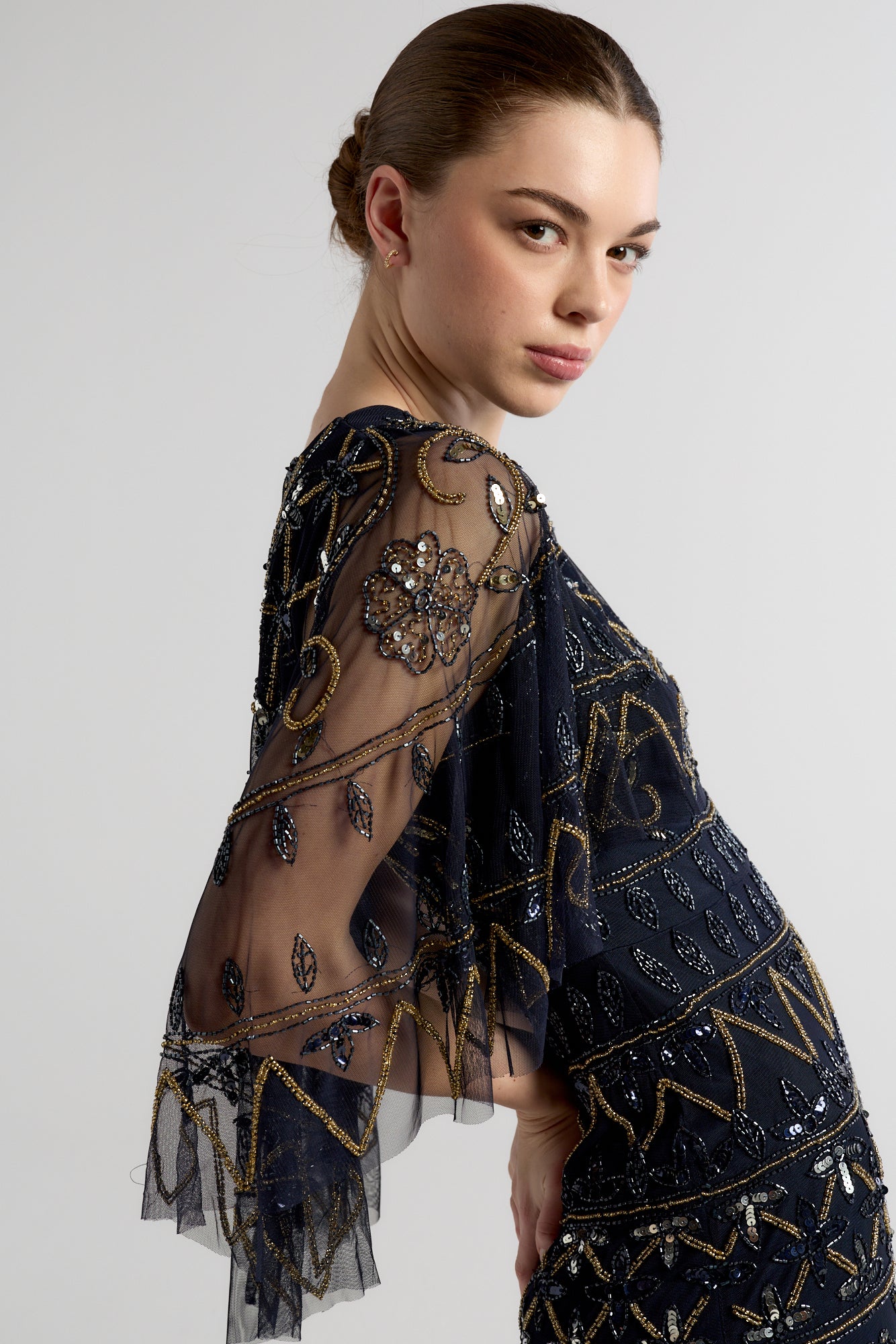 Navy Mahonia cape sleeve midaxi dress from Frock and Frill, fully embellished with sparkling beads, featuring a flowing skirt, perfect for weddings, parties, and modest evening occasions