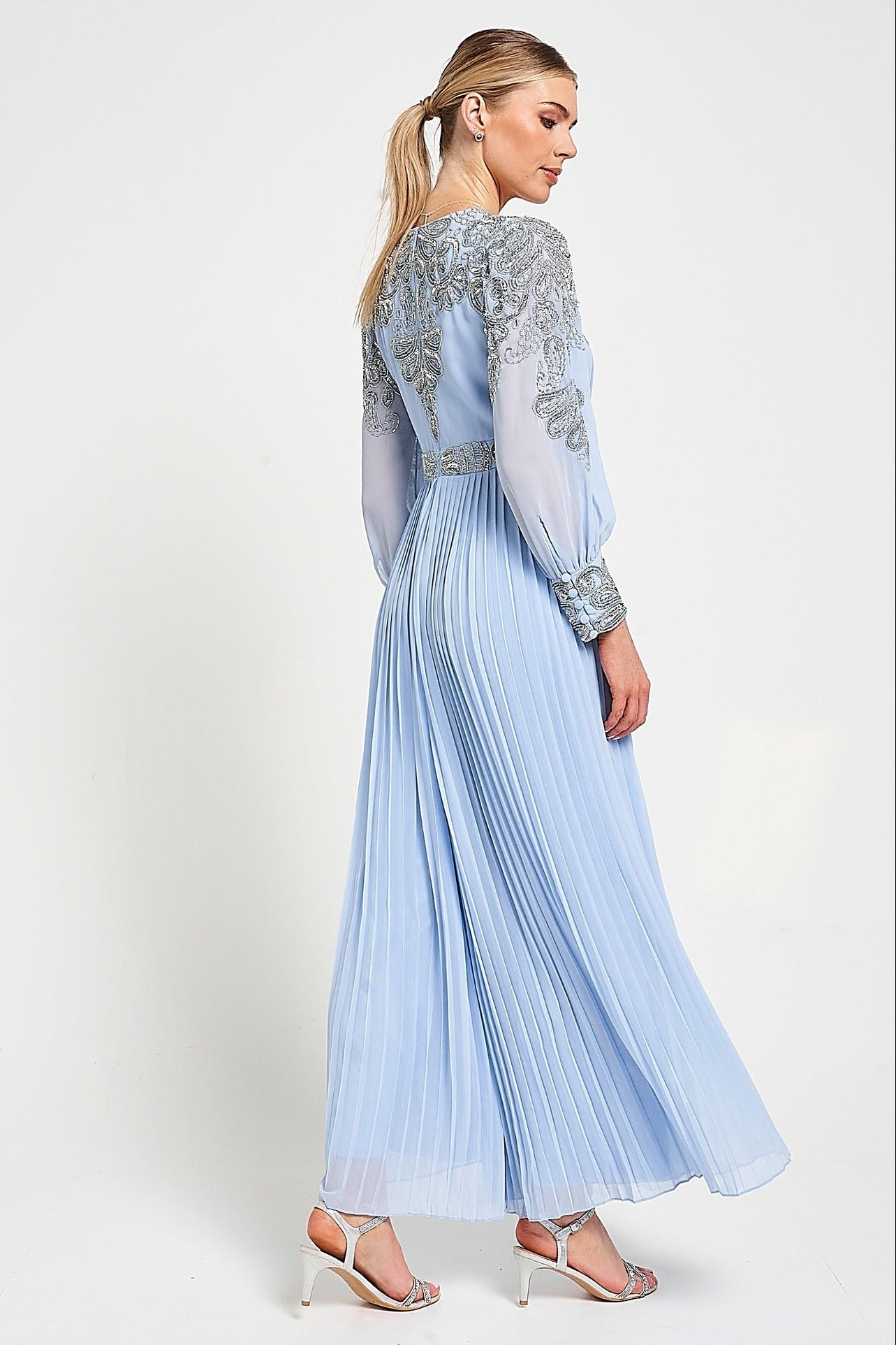 Meredith Blue Embellished Jumpsuit in ice blue with beaded bodice, long sheer sleeves and pleated wide-leg trousers for weddings and formal occasions.