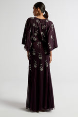 Naida dark purple embellished maxi dress with long sleeves, floral bead details, and floor-length flowing silhouette, suitable for weddings and formal occasions.