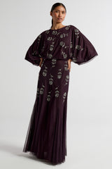 Naida dark purple embellished maxi dress with long sleeves, floral bead details, and floor-length flowing silhouette, suitable for weddings and formal occasions.