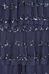 Nerissa dusty navy blue sequin tiered maxi dress with full-length sleeves, perfect for weddings, black tie balls and formal occasions. 