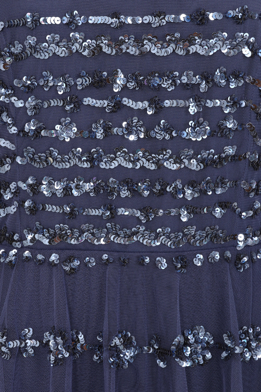 Nerissa dusty navy blue sequin tiered maxi dress with full-length sleeves, perfect for weddings, black tie balls and formal occasions. 