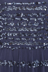 Nerissa dusty navy blue sequin tiered maxi dress with full-length sleeves, perfect for weddings, black tie balls and formal occasions. 