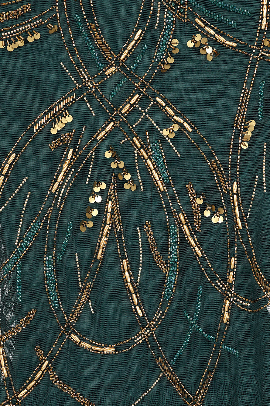 Green embellished maxi dress with flowing pleated skirt and detachable sheer cape overlay, featuring gold bead detailing and an elegant V-neck silhouette for occasion wear.