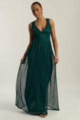 Green embellished maxi dress with flowing pleated skirt and detachable sheer cape overlay, featuring gold bead detailing and an elegant V-neck silhouette for occasion wear.
