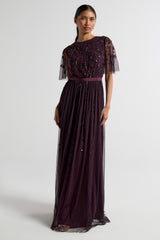 Talia dark purple embellished maxi dress with long sleeves, beaded bodice, and flowing skirt, suitable for bridesmaids or formal occasions.