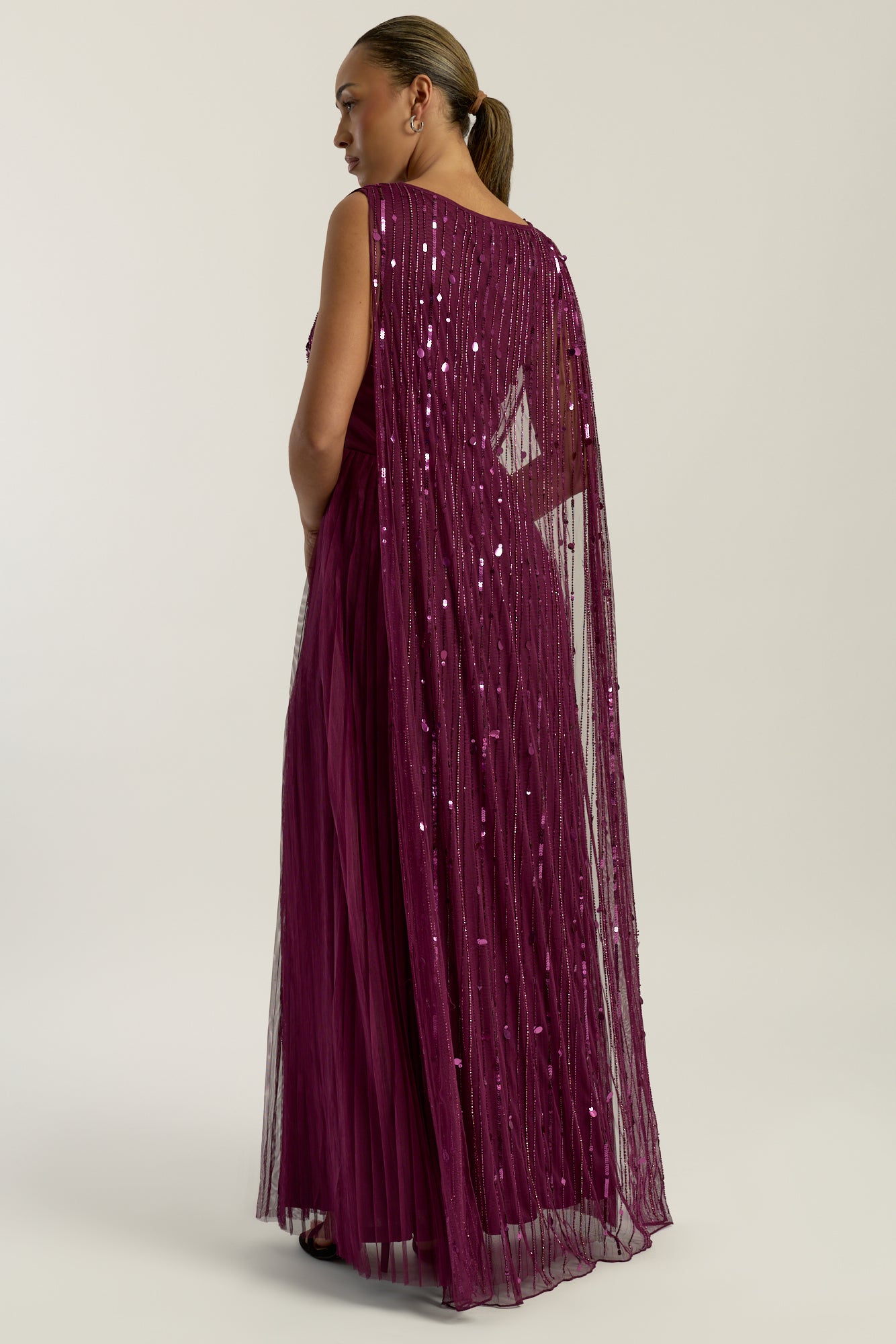 Valencia embellished maxi dress with sheer mesh overlay, intricate tonal beadwork and flowing pleated skirt, elegant beaded evening gown for weddings and formal occasions.