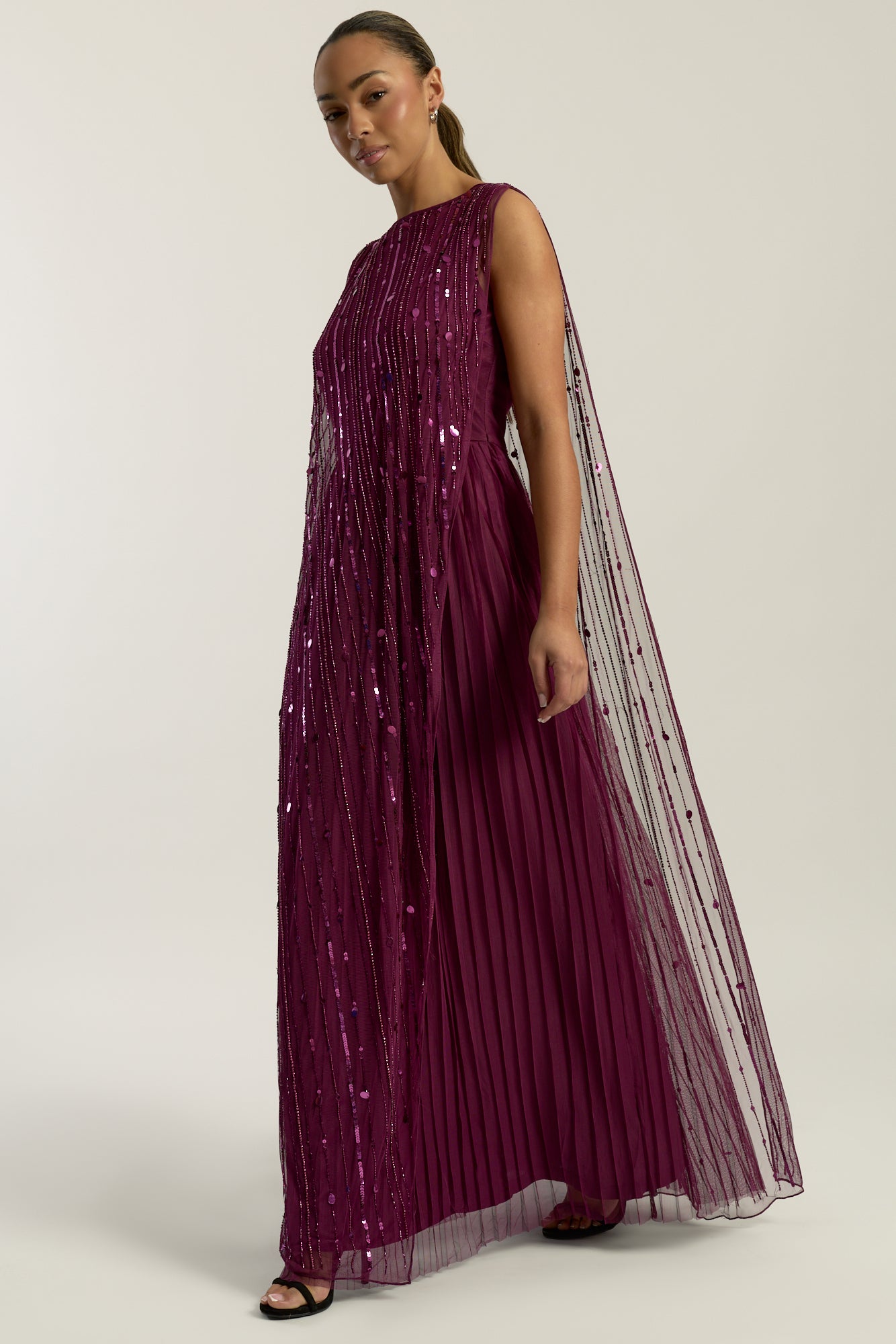 Valencia embellished maxi dress with sheer mesh overlay, intricate tonal beadwork and flowing pleated skirt, elegant beaded evening gown for weddings and formal occasions.
