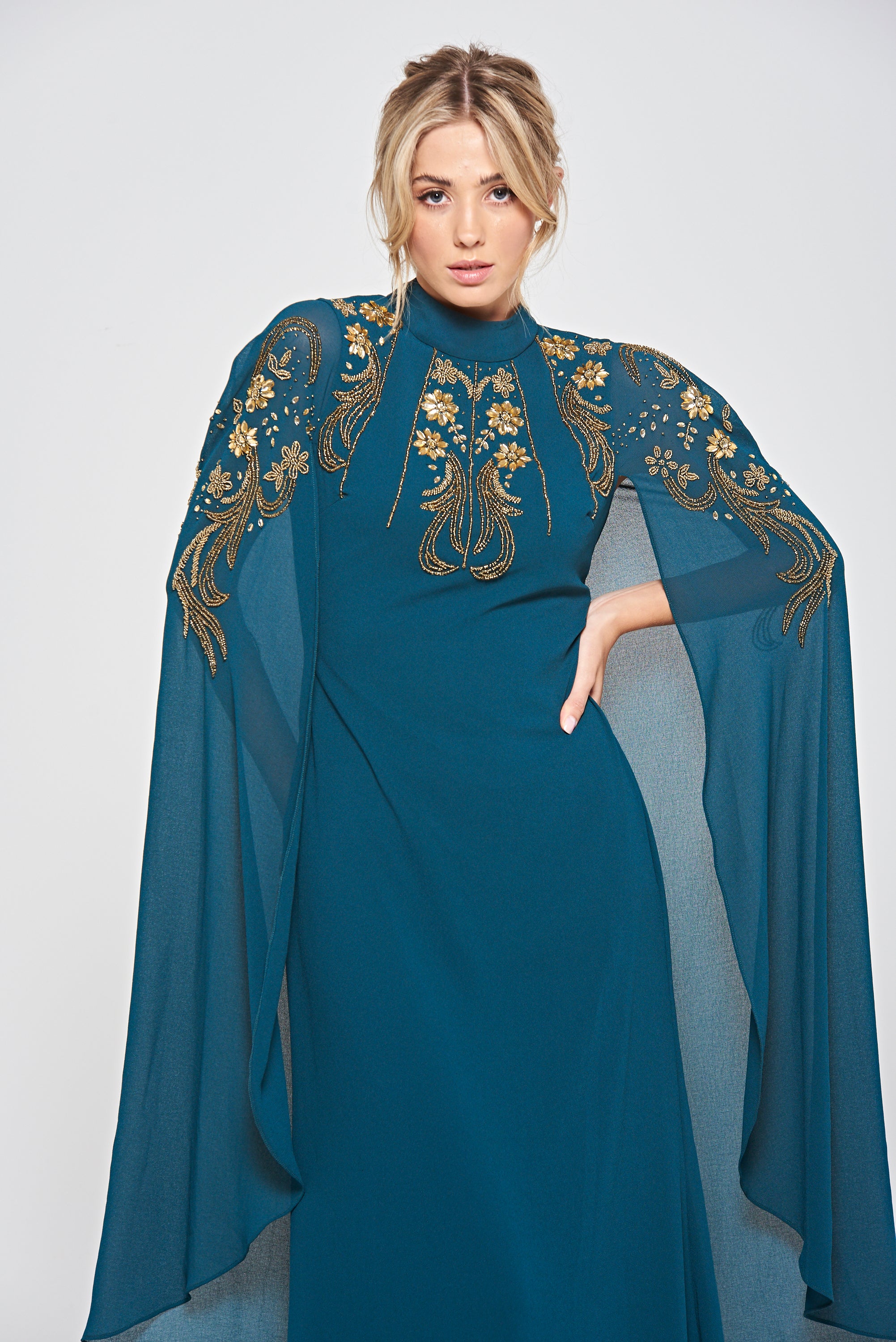Zinnia dark green embellished cape sleeve maxi dress with high neckline and flowing floor-length skirt, elegant modest evening gown for weddings and formal occasions.