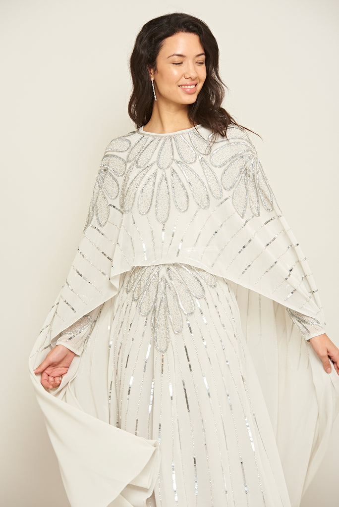 The White Color Frill Printed Long Length Gown with Tassels and Latkan is a  stylish and